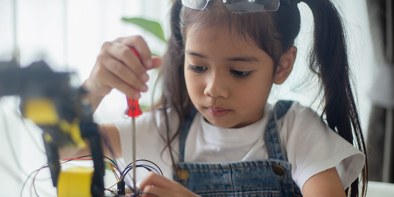 child conducting science experiment